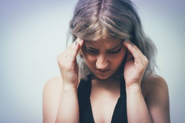 Baş ağrısı çeken kadın stüdyo geçmişine karşı