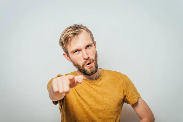 Young man showing his index finger towards the camera