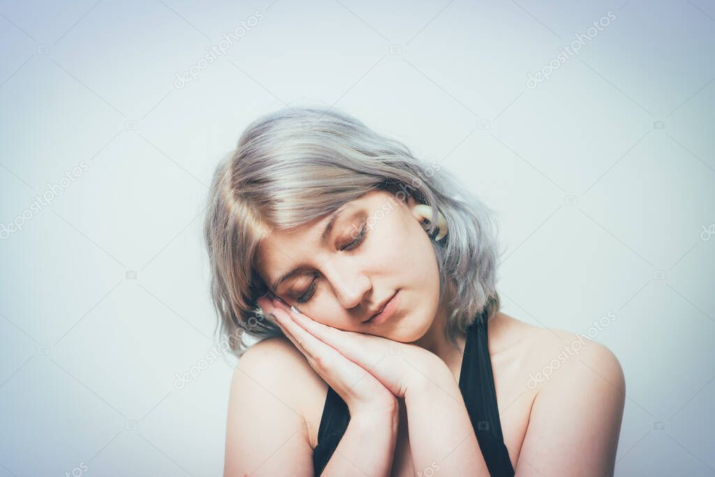 Sleep. Female against studio background