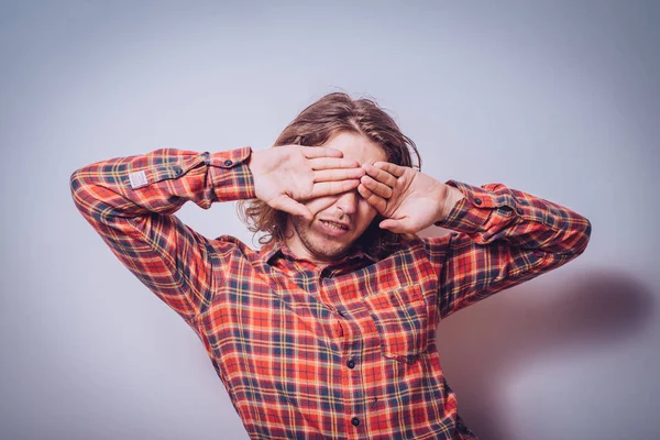 Man closes eyes with her hands