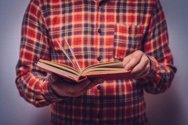 Elinde kitap olan adam.