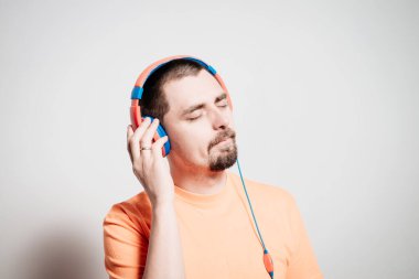 Kulaklıklı bir adam stüdyo geçmişine karşı.