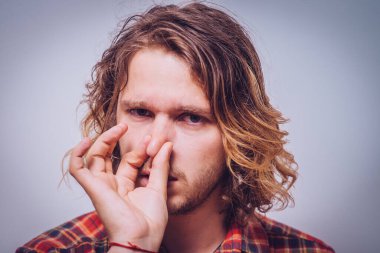 Leş gibi kokuyor. Adamın burnunu kapatır.