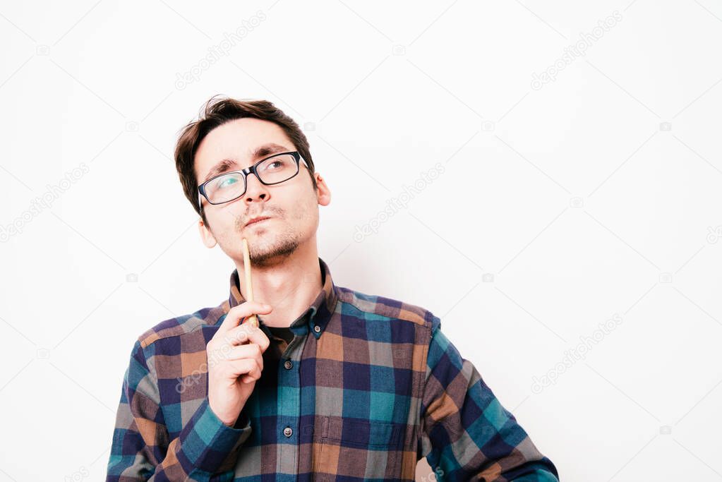 man is thinking about something with pencil