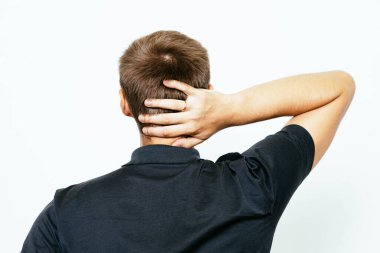 Kafasını tutarak. Arkadaki adam