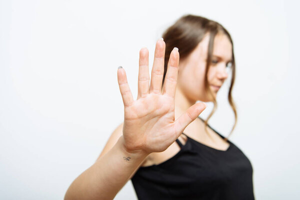 Stop gesture girl in studio background