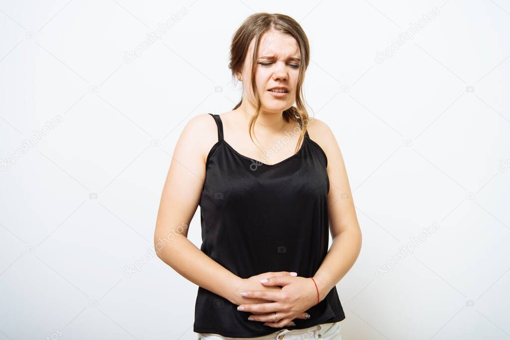 Stomach ache woman in photo studio