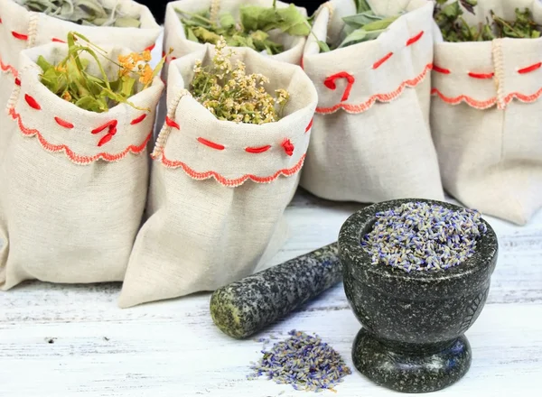 Mortar with lavender and dried medicinal and culinary herbs — Stock Photo, Image
