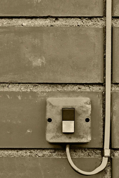 Elektrisk utrustning som används utomhus kontroll industriella knapp switch tråd kabel närbild, Gammal åldern klarat grungy tegel vägg bakgrund textur mönster, stora detaljerade vertikala texturerat grunge kopia utrymme i sepia — Stockfoto