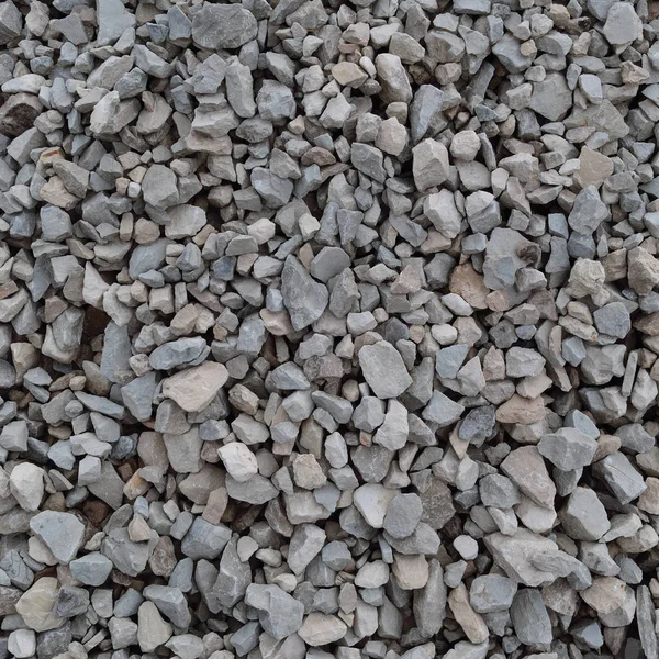 Fondo de piedra de grava gris y beige abstracto, piedras grises trituradas y textura de piezas de granito, patrón de mezcla de material de roca de construcción rugosa texturizada horizontal detallada grande — Foto de Stock