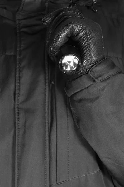 Gloved Hand Holding Tactical Flashlight, Bright Light Emiting Brightly Lit, Serrated Strike Bezel, Black Grain Leather Glove And Cop Jacket, Large Detailed Vertical Closeup, Patrolling Police Security Guard Staff Policeman, Covert Operations Patrol — Stock Photo, Image