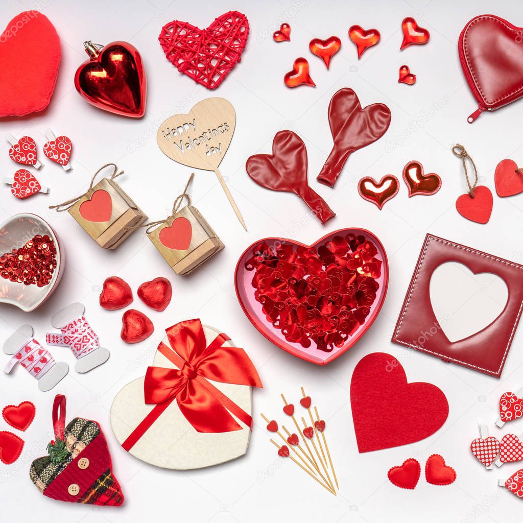 Various hearts and stylish accessories in heart shape, gifts and sweets in red color on white background. Empty photoframe, mock up. Greeting card for Valentine's day, love and romance concept