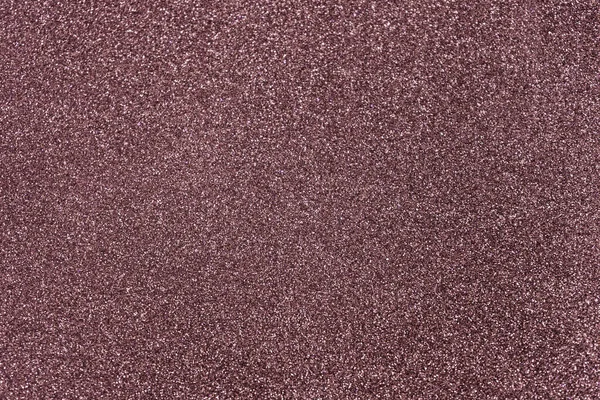 Rose brown glitter twinkle abstract New Year or Christmas holiday background with sparkles. Modern luxury mock up with sequins. Texture of colored porous rubber with spangles.