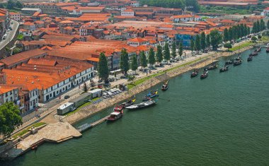 PORTO, PORTUGAL - 25 JUNE, 2010: Old town cityscape on the Douro River with traditional Rabelo boats in Porto, Portugal.