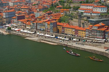 PORTO, PORTUGAL - 25 JUNE, 2010: Old town cityscape on the Douro River with traditional Rabelo boats in Porto, Portugal.