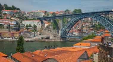 PORTO, PORTUGAL - 25 JUNE, 2010: Old town cityscape on the Douro River with traditional Rabelo boats in Porto, Portugal.