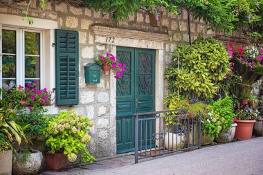 KOTOR, MONTENEGRO - 10 AĞUSTOS, 2019: Karadağ 'ın Kotor Körfezi' nde çiçekli geleneksel ev.