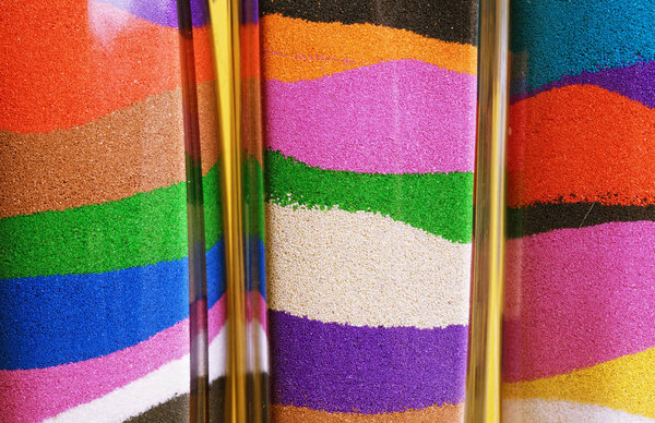 Glass bottles with colored sand. Sand art in a bottle - close up