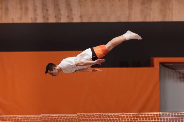 Zarif uçuş trambolin üzerinde genç atlet.