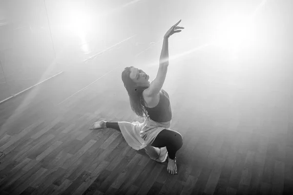 Hermosa chica baila elegantemente en humo y niebla . — Foto de Stock