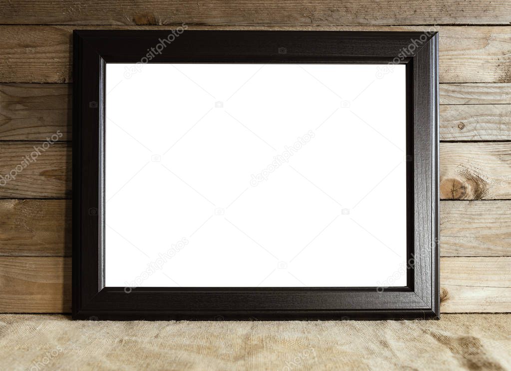 Black frame on wooden background