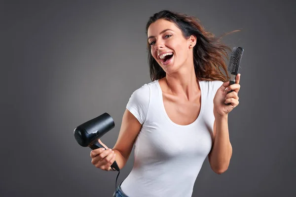 Young woman with hairdryer — Stock Photo, Image