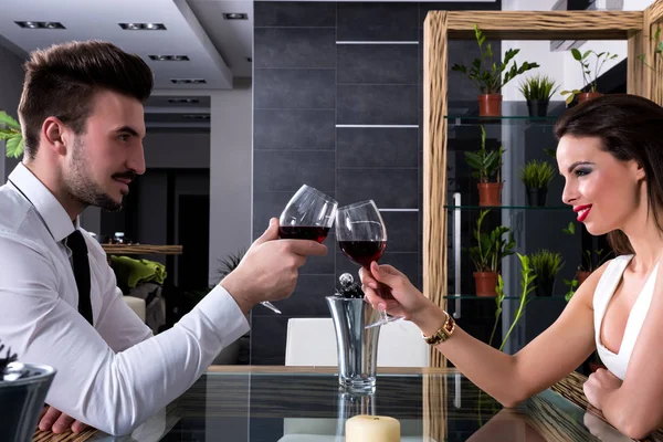 Young couple drinking wine in the evening — Stock Photo, Image