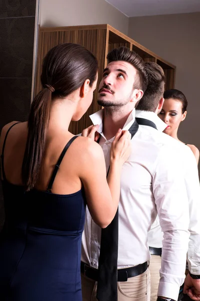 A young couple getting dressed in the changing room — Stock Photo, Image