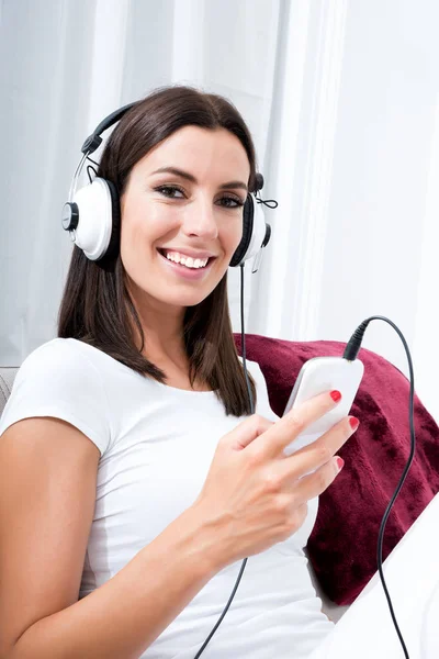 Hermosa mujer joven en auriculares escuchando música —  Fotos de Stock