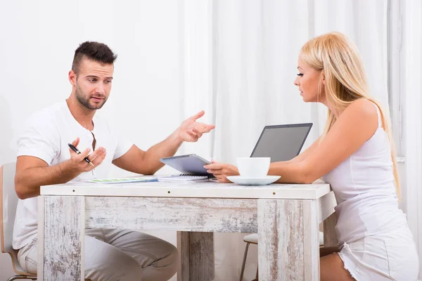 A beautiful young couple discuss business — Stock Photo, Image