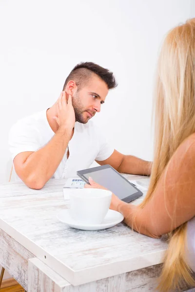 A beautiful young couple discuss business — Stock Photo, Image