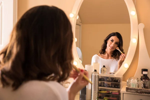 Eine schöne junge Frau an einem Schminktisch — Stockfoto