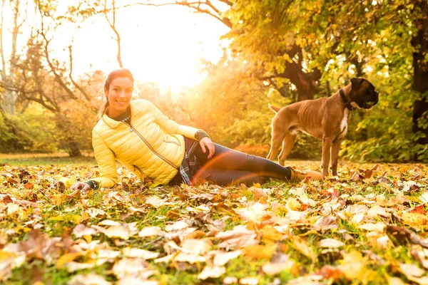 Jovem mulher abraçando seu cão no parque — Fotografia de Stock