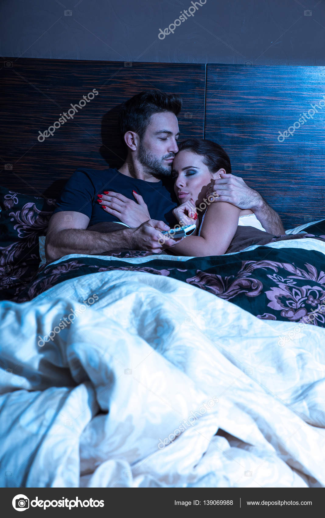 Beautiful Young Couple Being Scared In Bed Stock Photo