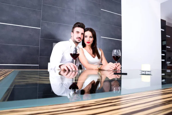 Ein romantisches Paar mit einem Glas Wein im Speisesaal — Stockfoto