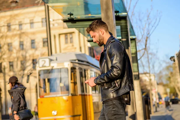 Молодой человек ждет на трамвайной станции — стоковое фото
