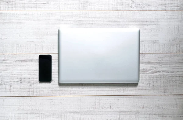 Tabletop with a laptop and mobile — Stock Photo, Image