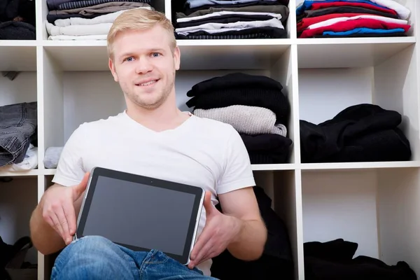 Young man with his wardrobe — Stock Photo, Image