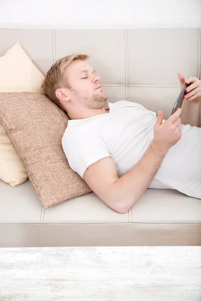 With the phone on the sofa — Stock Photo, Image