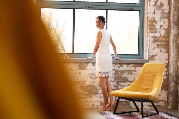 Fashion portrait of a beautiful young woman in a dress — Stock Photo, Image