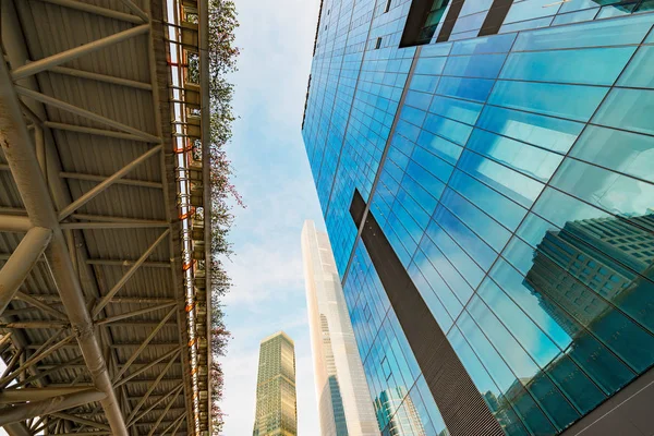 Bottom view of modern skyscrapers in business district against blue sky — Stock Photo, Image