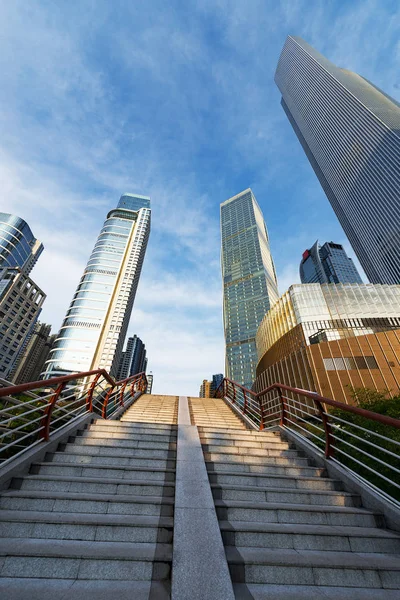 Bottom view of modern skyscrapers in business district against blue sky — Stock Photo, Image