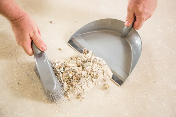 Worker Picking Up Pile of Debris on Cement — Stock Photo, Image