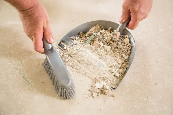 Worker Picking Up Pile of Debris on Cement — Stock Photo, Image