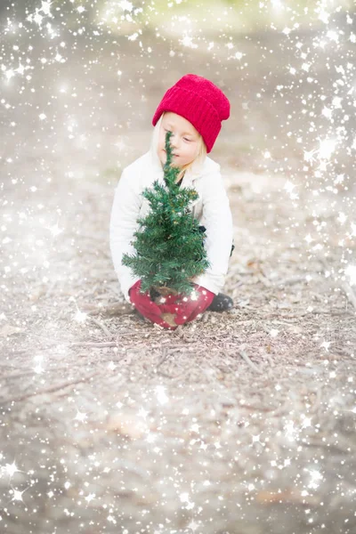 Girl In Red Mittens and Cap Near Small Christmas Tree with Snow — Stock Photo, Image