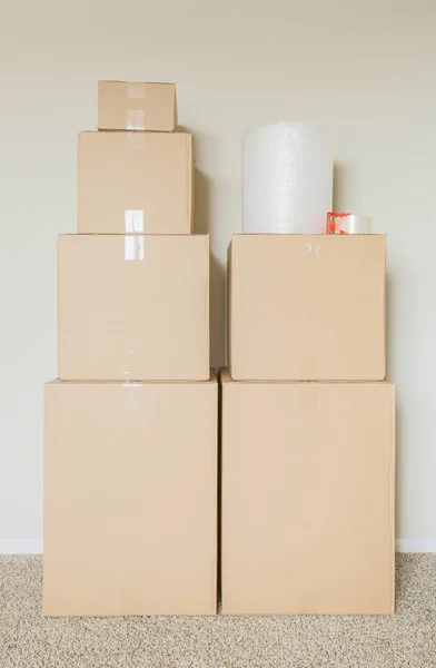 Variety of Packed Moving Boxes In Empty Room — Stock Photo, Image