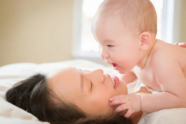 Mixed Race Chinese and Caucasian Baby Boy Laying In Bed with His — Stock Photo, Image