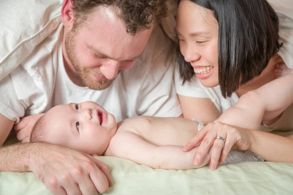 Raza mixta chino y caucásico bebé acostado en la cama con su — Foto de Stock