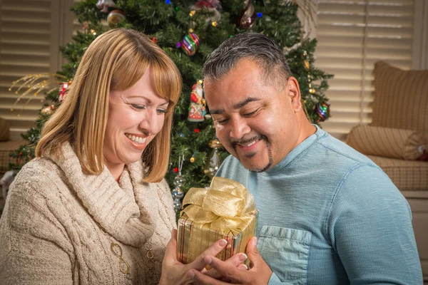 Young Mixed Race Couple with Present Near Christmas Tree — Stock Photo, Image