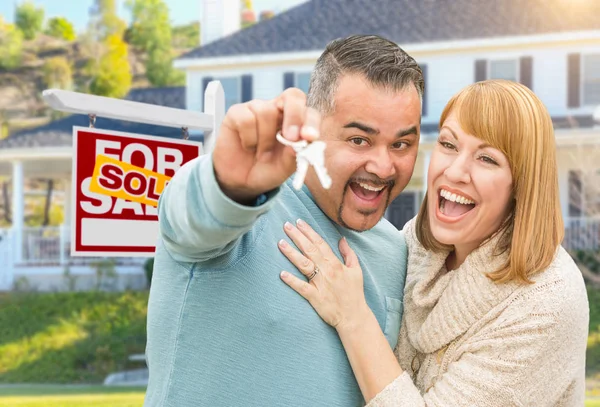 Mixed Race Couple With Keys in front of Real Estate Sign and New — стоковое фото